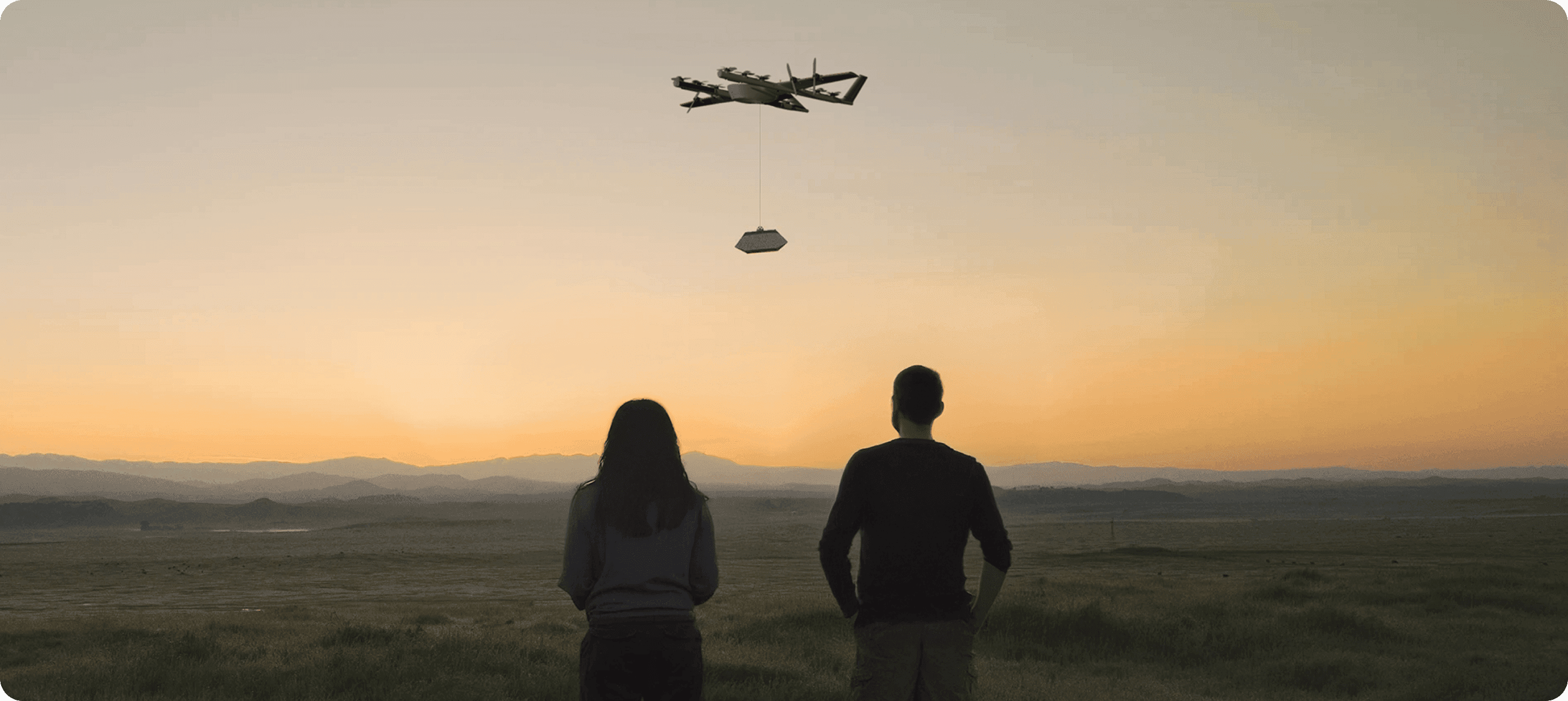 Wing delivery drone flying at sunset
